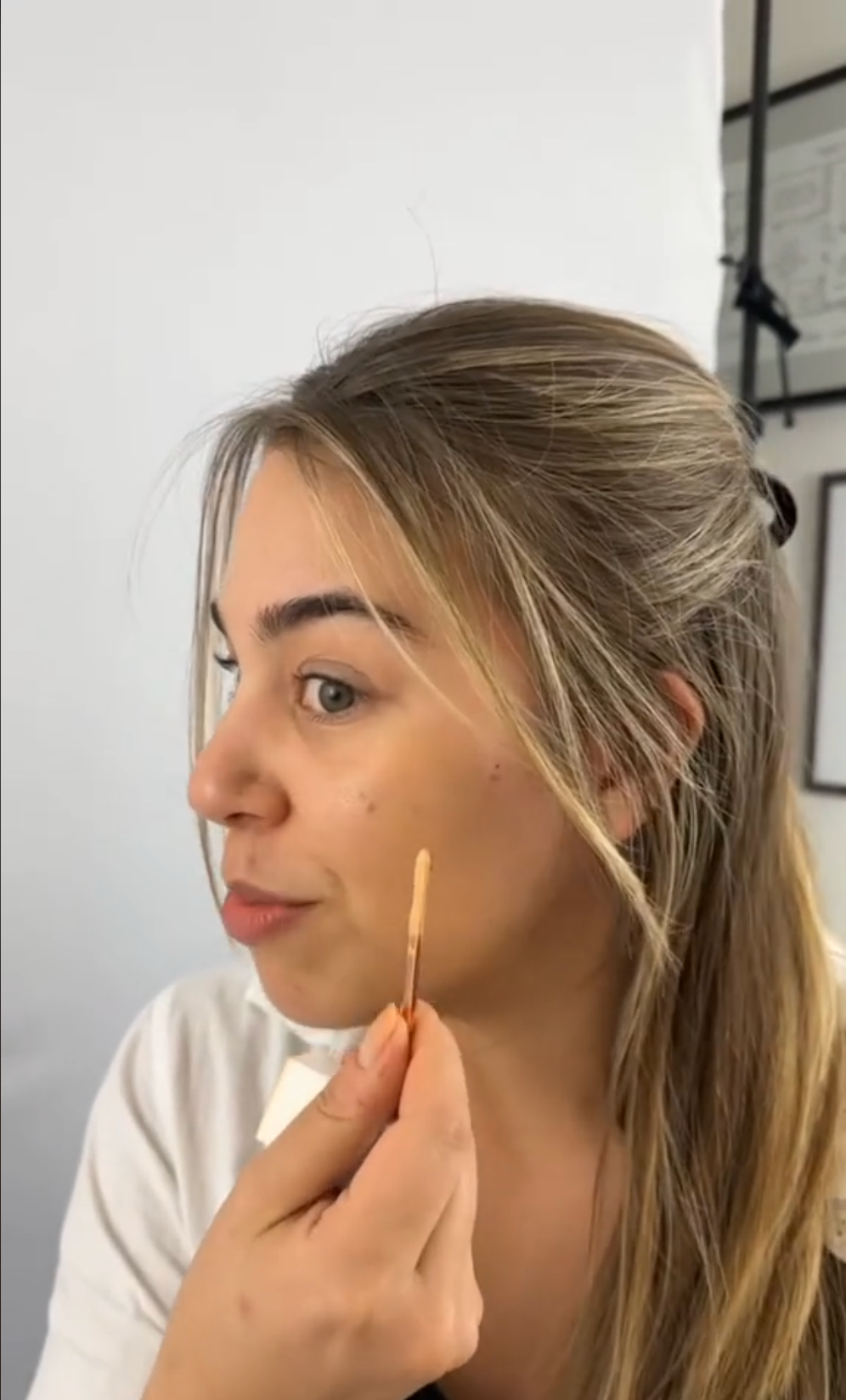 a woman getting ready to apply the boldhue foundation to her face showing that it is a perfect match for her skin tone
